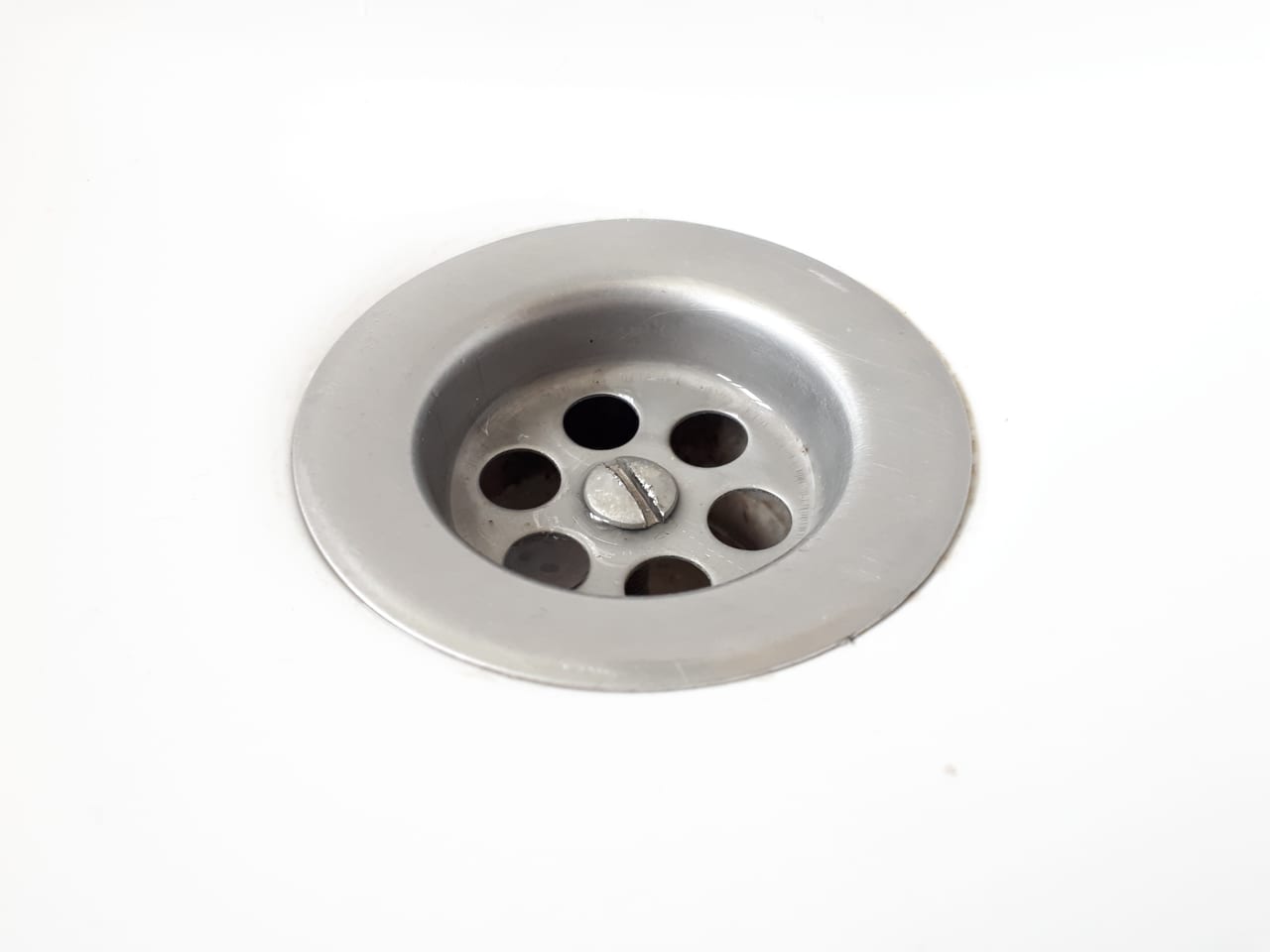 Bathroom basin drain and overflow, representative fixture photograph