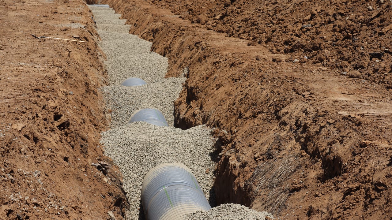 Drainage trench and gravel bedding, representative ground-access photograph